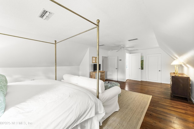 bedroom featuring vaulted ceiling, dark hardwood / wood-style floors, and ceiling fan