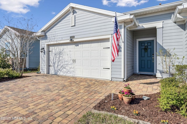 view of front of house featuring a garage and decorative driveway