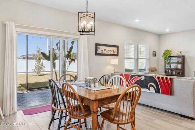 dining room with an inviting chandelier, light wood-style flooring, and recessed lighting