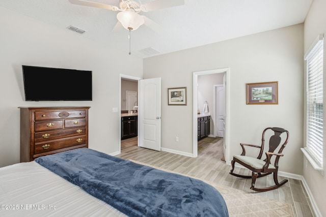 bedroom with visible vents, connected bathroom, light wood-style flooring, and baseboards