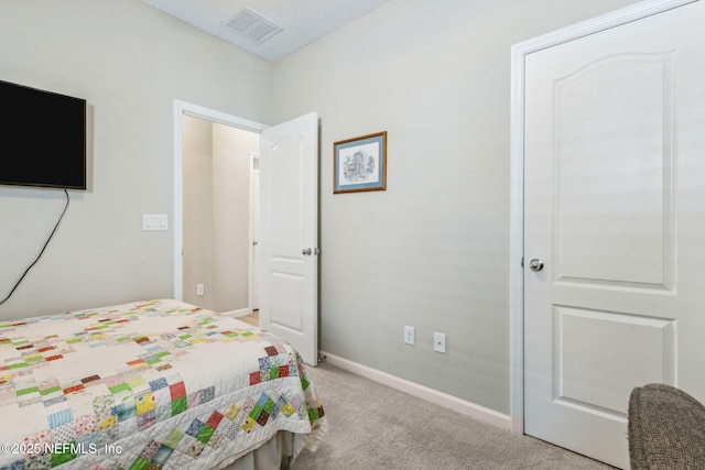 bedroom with baseboards, visible vents, and light colored carpet