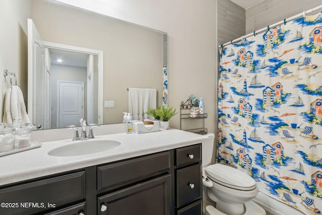 bathroom with curtained shower, vanity, and toilet