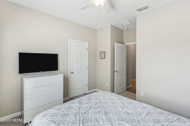 bedroom with ceiling fan, visible vents, and baseboards