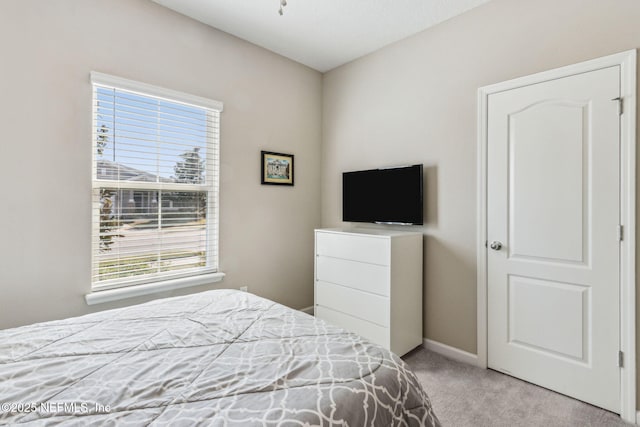 bedroom featuring carpet floors and baseboards