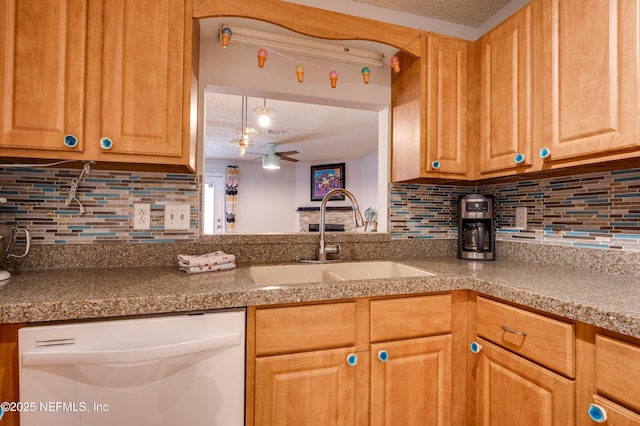 kitchen with dishwasher, sink, backsplash, ceiling fan, and a textured ceiling