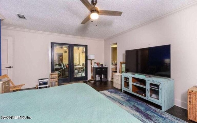 bedroom with ornamental molding, french doors, and a textured ceiling