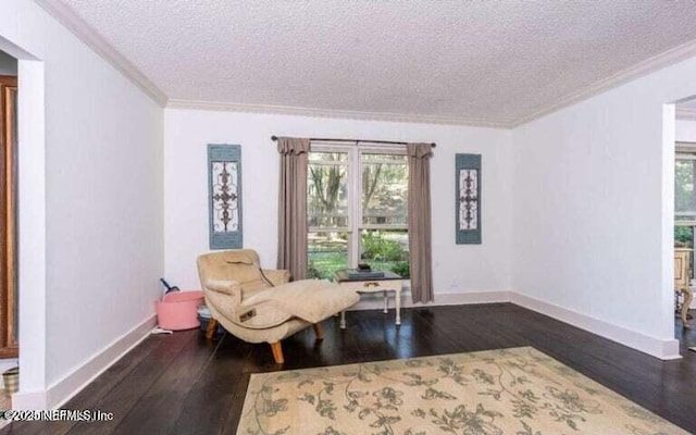 living area featuring ornamental molding, dark hardwood / wood-style flooring, and a textured ceiling