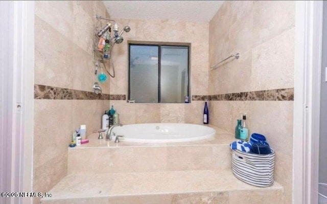 bathroom with tile walls and tiled tub