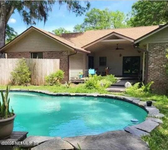 view of pool featuring ceiling fan