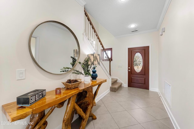 foyer featuring ornamental molding and light tile patterned floors