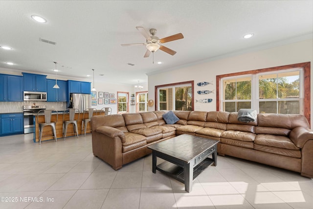 living room featuring crown molding, plenty of natural light, and light tile patterned flooring