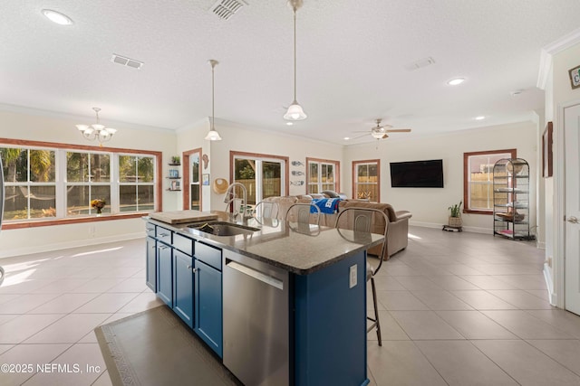 kitchen featuring blue cabinetry, sink, a breakfast bar area, stainless steel dishwasher, and pendant lighting