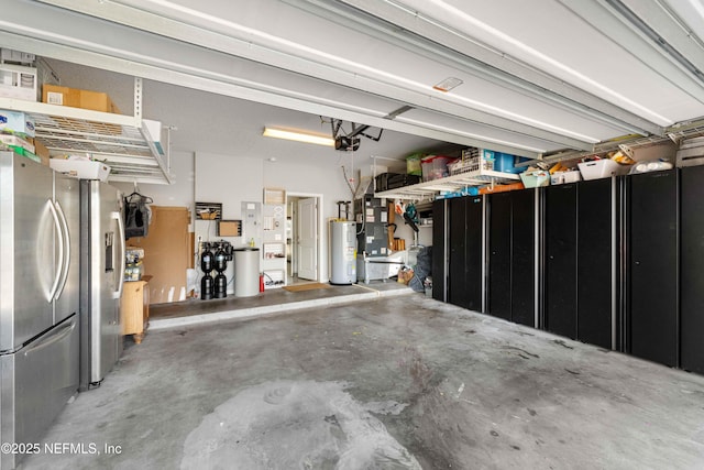 garage featuring stainless steel refrigerator, a garage door opener, and water heater