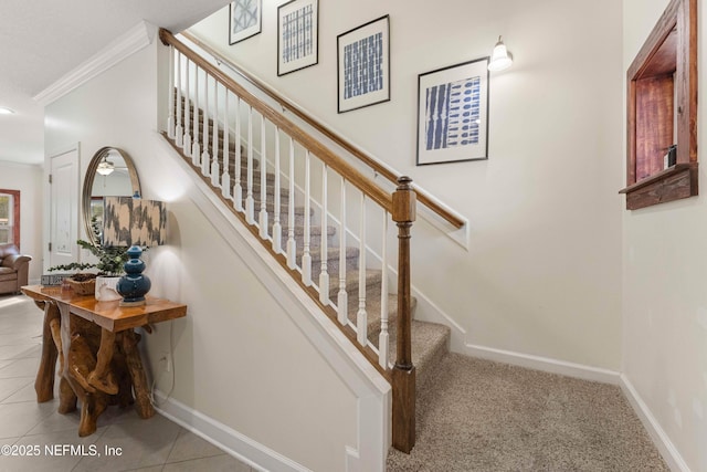 staircase with ornamental molding and tile patterned floors