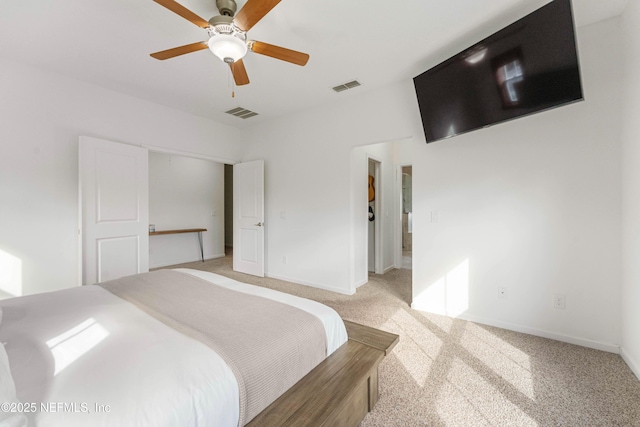 bedroom with ceiling fan and light carpet