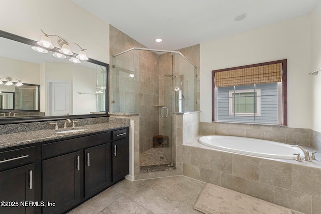 bathroom with vanity and independent shower and bath