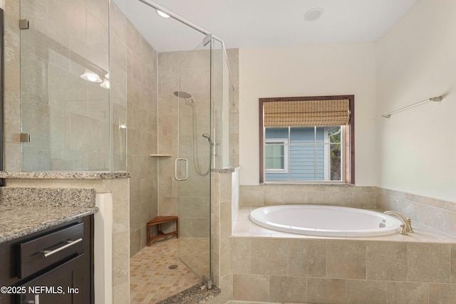 bathroom featuring shower with separate bathtub and vanity