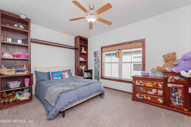 carpeted bedroom with ceiling fan and a textured ceiling