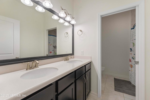 bathroom with tile patterned floors, toilet, and vanity