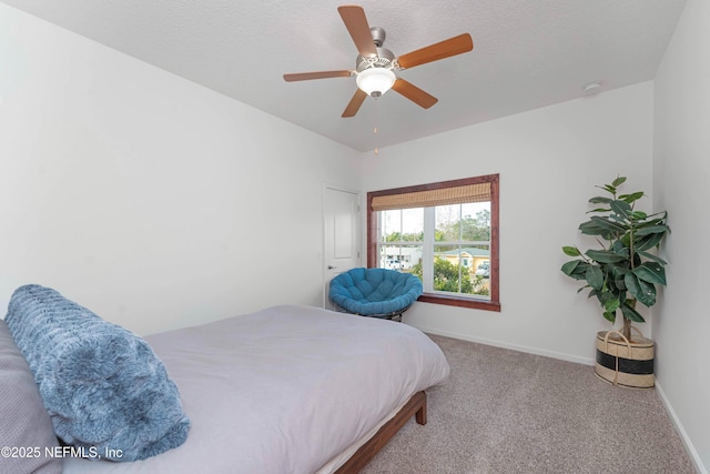 bedroom with carpet, a textured ceiling, and ceiling fan