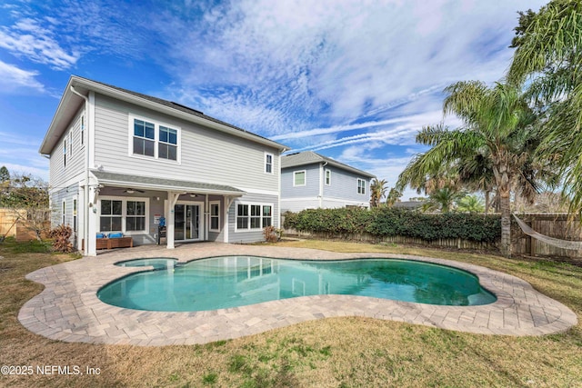 back of property featuring a fenced in pool, an outdoor living space, a patio area, and ceiling fan