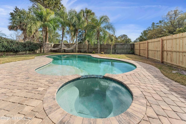 view of pool featuring an in ground hot tub and a patio area