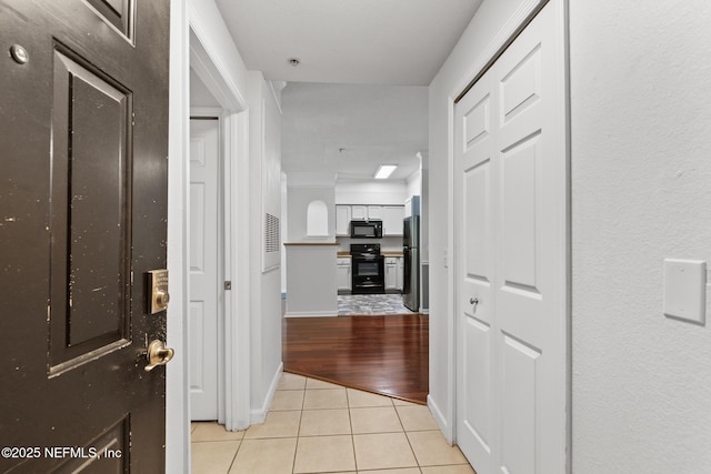 corridor featuring light tile patterned flooring