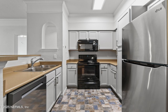 kitchen with gray cabinetry, ornamental molding, sink, and black appliances