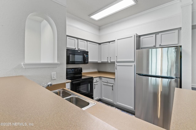 kitchen featuring gray cabinetry, ornamental molding, sink, and black appliances