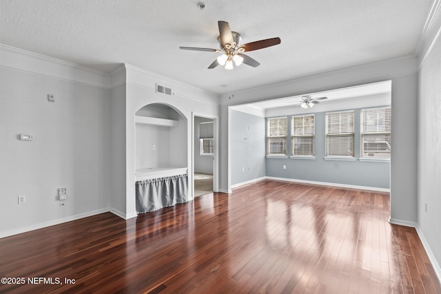 unfurnished living room with hardwood / wood-style floors, ornamental molding, and a textured ceiling