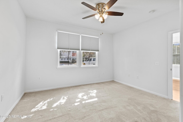 spare room featuring ceiling fan and light carpet