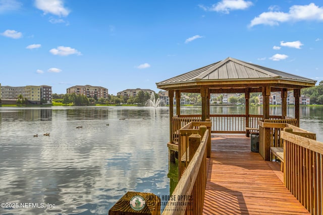 view of dock featuring a gazebo and a water view