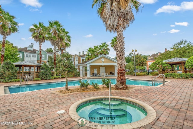 view of swimming pool with a gazebo, a hot tub, and a patio