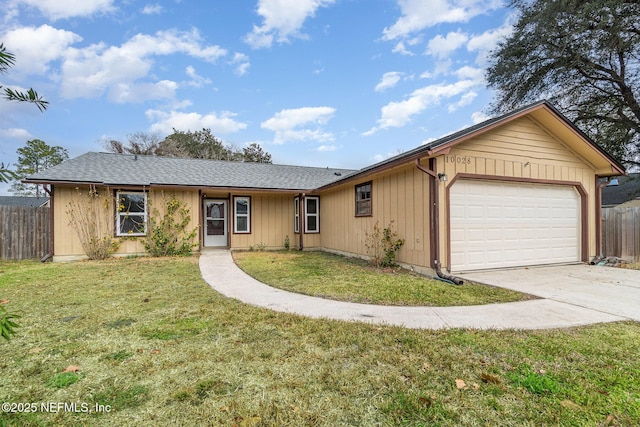 ranch-style home featuring a garage and a front lawn