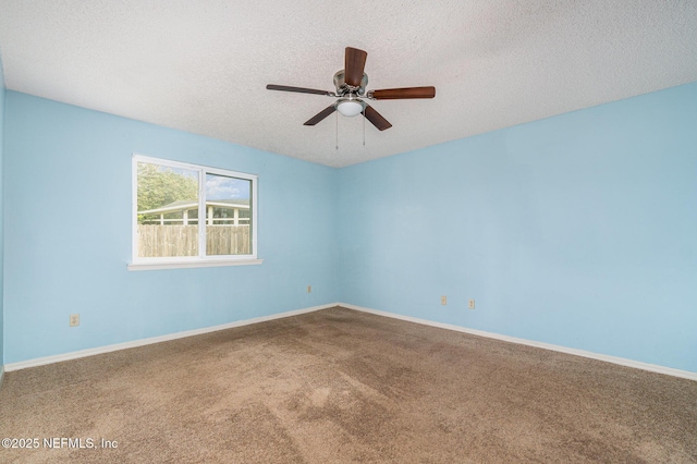 carpeted spare room featuring ceiling fan and a textured ceiling