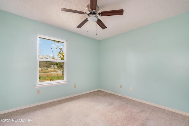 carpeted empty room featuring ceiling fan and a textured ceiling