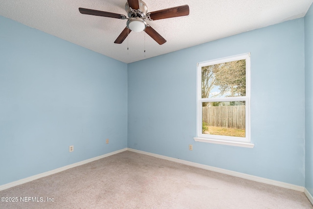 spare room with ceiling fan, carpet flooring, and a textured ceiling