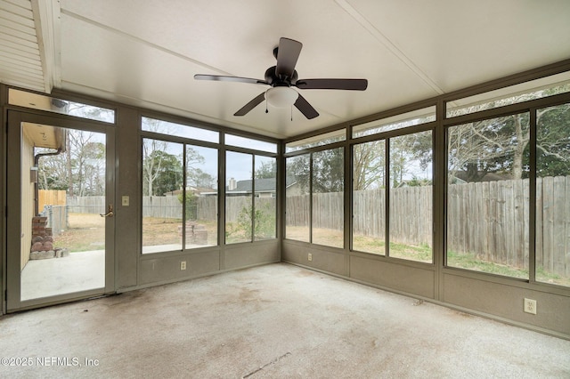 unfurnished sunroom with ceiling fan