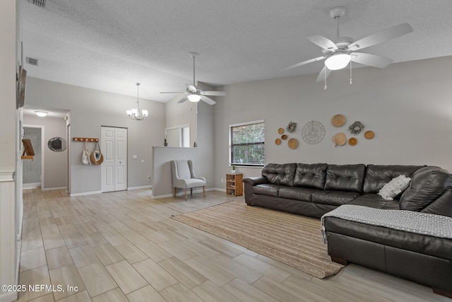 unfurnished living room with ceiling fan with notable chandelier, vaulted ceiling, a textured ceiling, and light hardwood / wood-style flooring