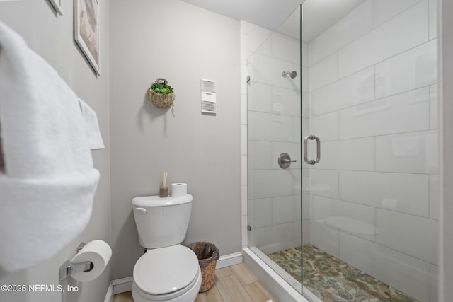 bathroom with walk in shower, hardwood / wood-style floors, and toilet