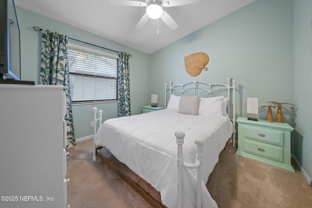 bedroom featuring lofted ceiling, carpet flooring, a textured ceiling, and ceiling fan