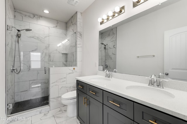 bathroom with toilet, vanity, and a shower with shower door