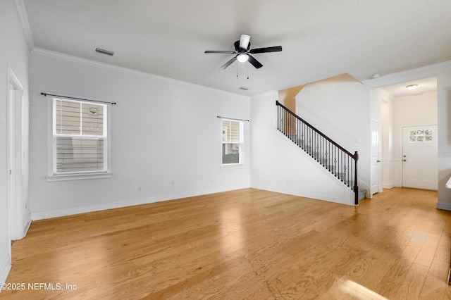 unfurnished living room featuring ceiling fan, ornamental molding, and light wood-type flooring