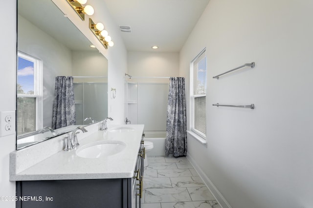 full bathroom with vanity, shower / bath combo, toilet, and a healthy amount of sunlight