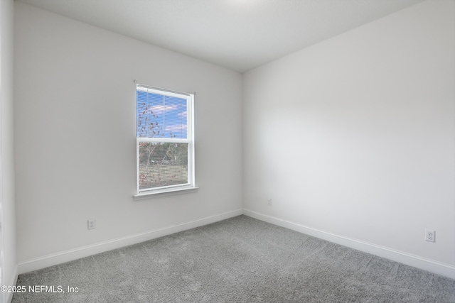 unfurnished room featuring carpet