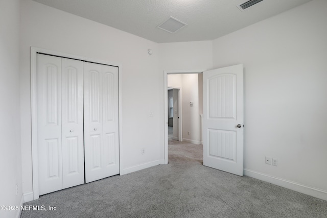 unfurnished bedroom featuring a closet and light carpet