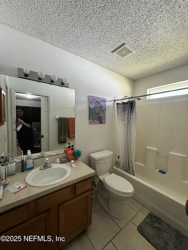 full bathroom featuring vanity, shower / tub combo, toilet, tile patterned floors, and a textured ceiling