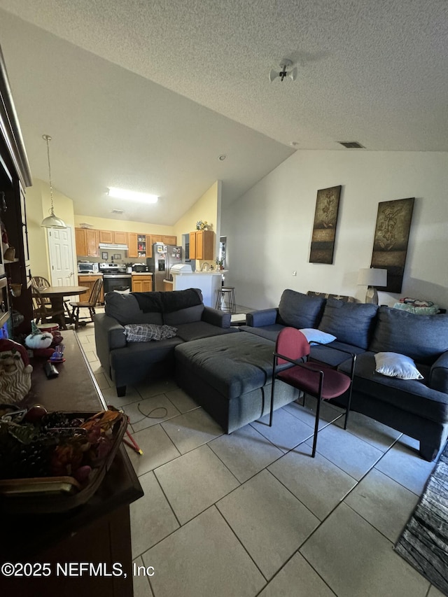 tiled living room with vaulted ceiling and a textured ceiling