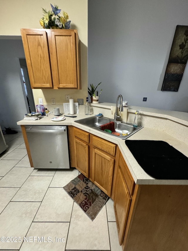 kitchen with light tile patterned flooring, stainless steel dishwasher, kitchen peninsula, and sink