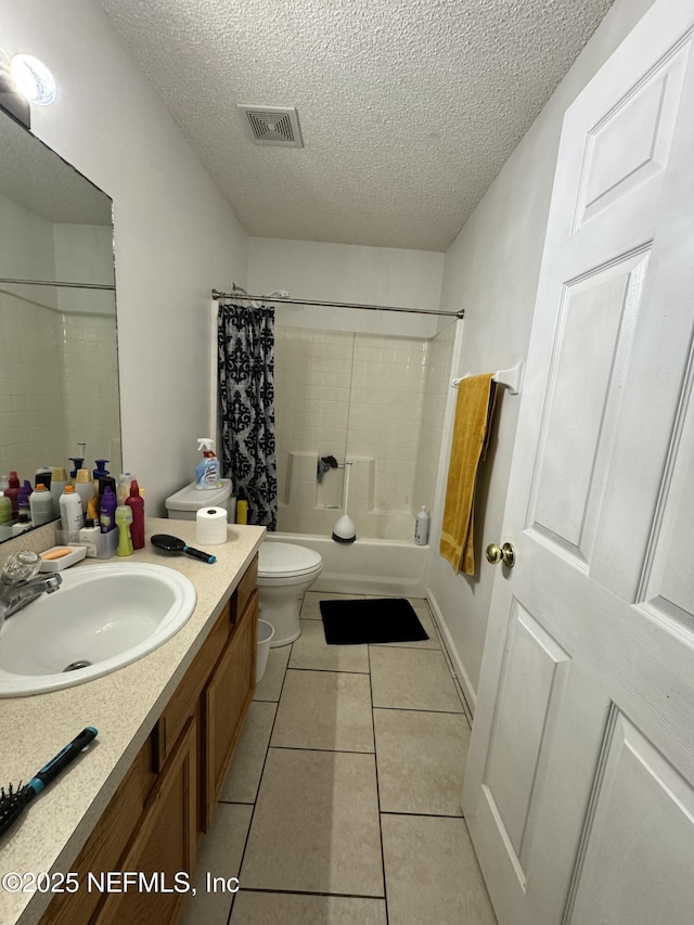 full bathroom featuring vanity, shower / bath combination with curtain, a textured ceiling, tile patterned floors, and toilet